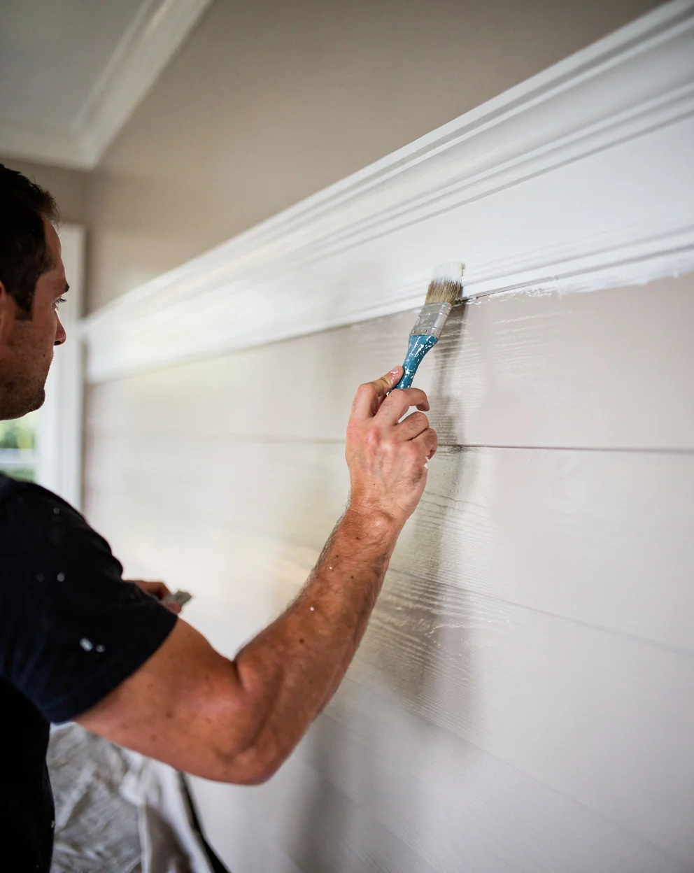Primeline painter cutting a crisp line on a freshly repainted Gold Coast home